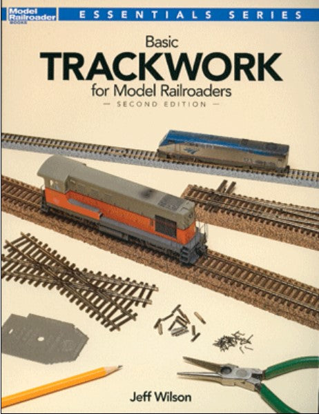 Book cover of 'Basic Trackwork for Model Railroaders' with model train tracks and tools on a beige background.