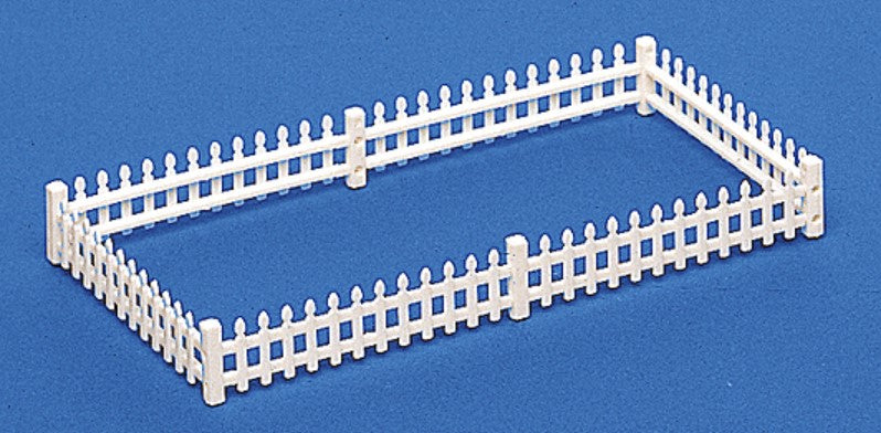 White picket fence model on a blue background