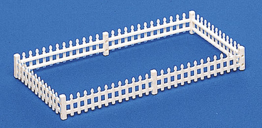 White picket fence model on a blue background