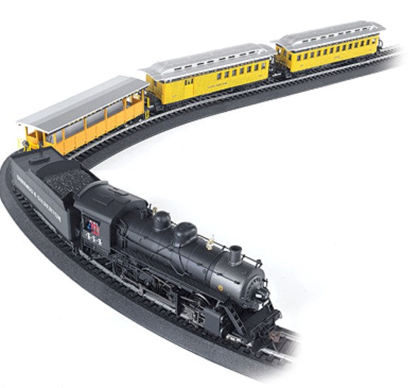 Model train set with black steam locomotive and yellow passenger cars on a white background